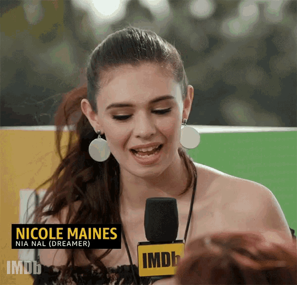a woman named nicole maines is speaking into a microphone