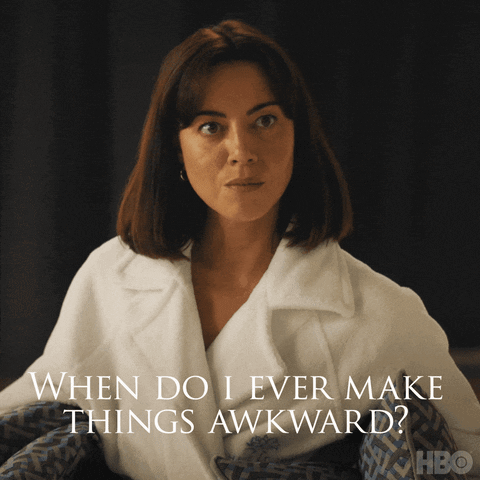 A woman gives an uneasy stare in a dimly lit scene with text asking “When do I ever make things awkward?”