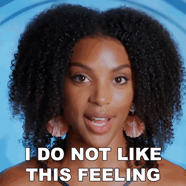 a woman with curly hair and earrings says i do not like this feeling