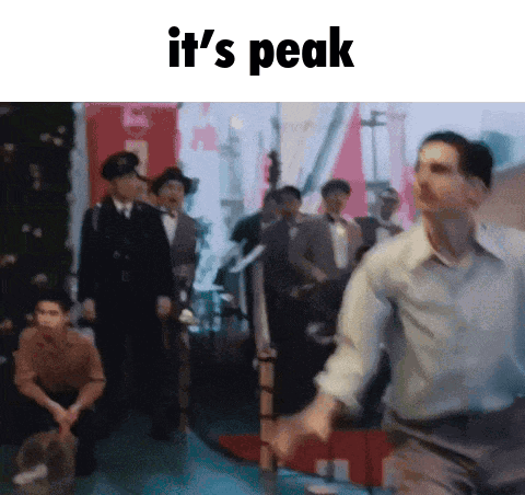 a man is running in front of a group of people with the words it 's peak above him