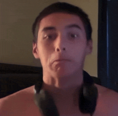 a man without a shirt is wearing headphones around his neck
