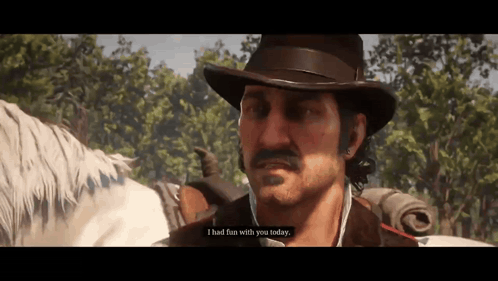 a man in a hat is standing next to a horse and talking to it .