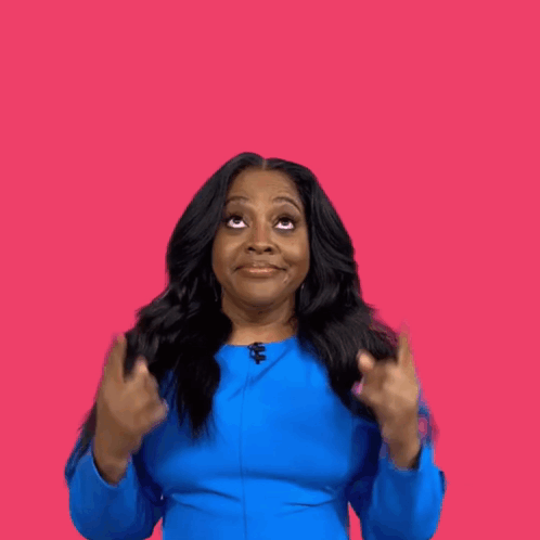 Sherri Shepherd raises both hands in an animated “oops” reaction.