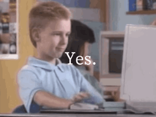 A young person at a computer gives an approving look with “Yes.” text.