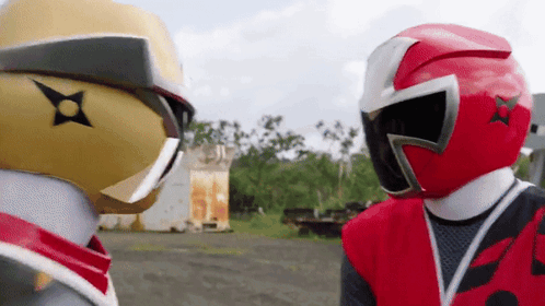 two ninja rangers are standing next to each other in a field