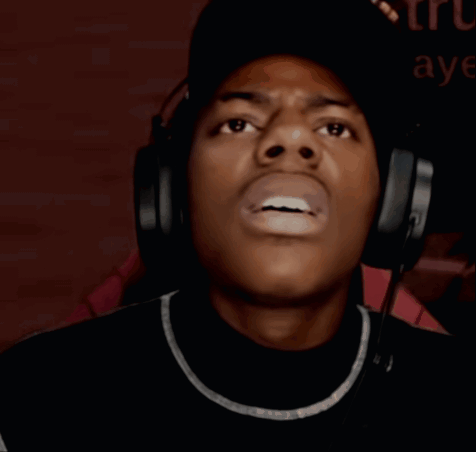IShowSpeed looks upward in confusion while wearing headphones.