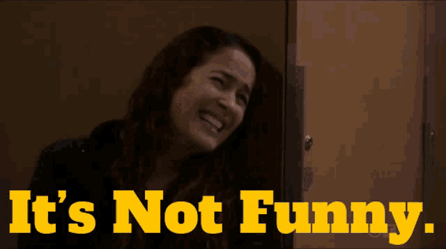 a woman laughing with the words " it 's not funny " behind her