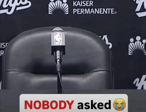 a sign that says nobody asked sits in front of a chair