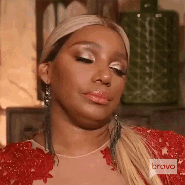 Nene Leakes looks away with a weary, disappointed expression.