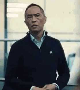 A man holds both hands out in a firm stop gesture.
