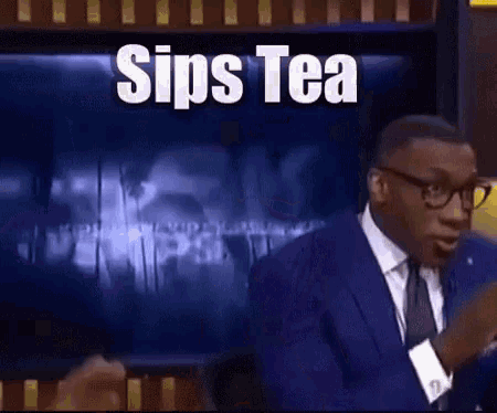 a man in a suit and tie is talking in front of a screen that says sips tea