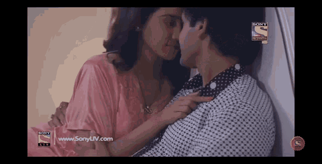 a woman kissing a man on a sony tv screen