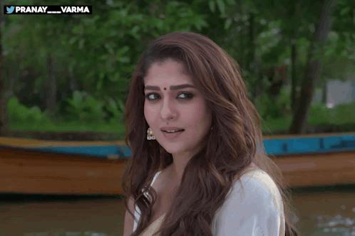 Nayanthara looks toward the camera outdoors.