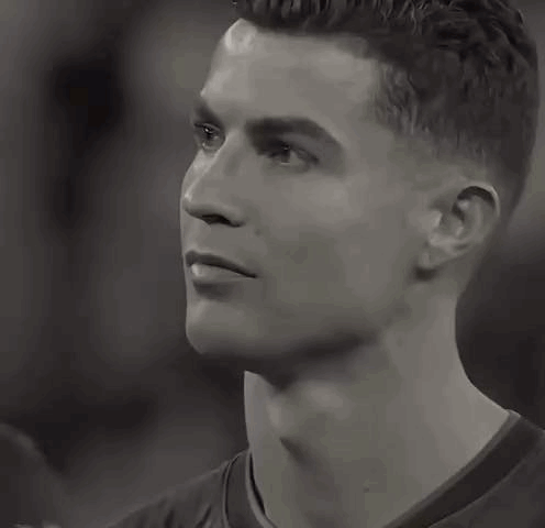 Cristiano Ronaldo looks solemn and emotional in a grayscale close-up.