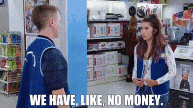 a man and a woman are standing next to each other in a store and the woman is talking to the man .