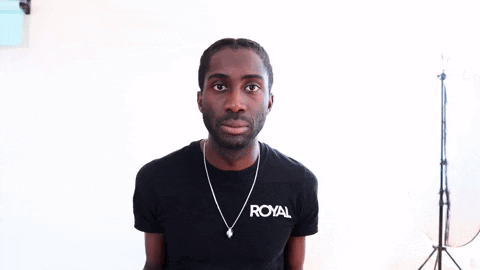 a man wearing a black t-shirt that says royal on it