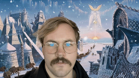 a man with glasses and a mustache in front of a snowy scene