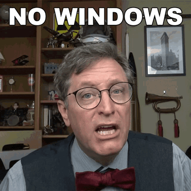 a man wearing glasses and a bow tie has the words " no windows " on his face
