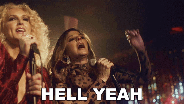 two women singing in front of microphones with the words hell yeah above them