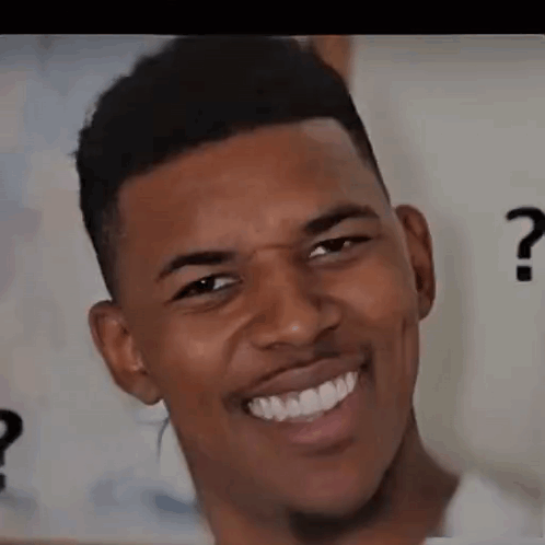 A man smiles uncertainly while a question mark appears behind him.
