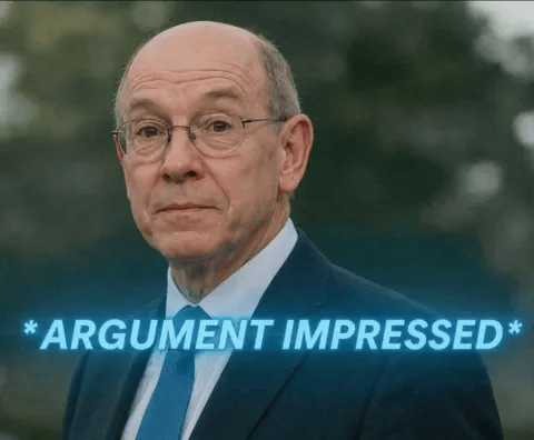 a man in a suit and tie is standing in front of a sign that says argument impressed