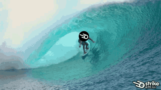 a person riding a wave with a strike logo on the bottom right