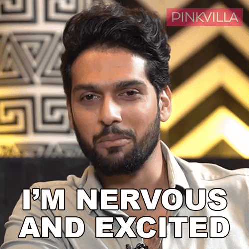a man with a beard says " i 'm nervous and excited " in front of a pinkvilla logo