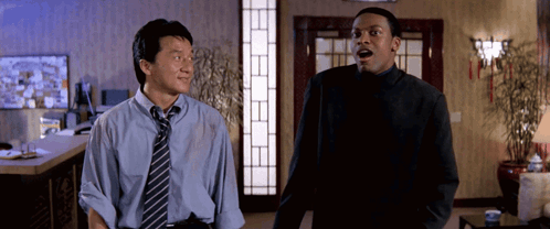 a man in a blue shirt and tie stands next to another man with his mouth open