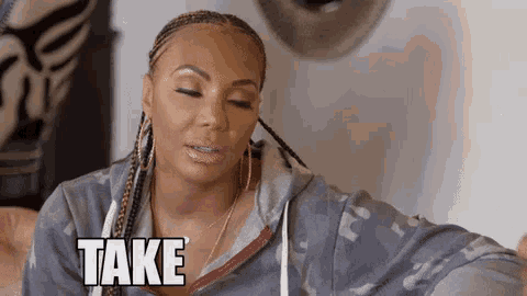 a woman with braids is sitting down with her eyes closed and the word take on her face .