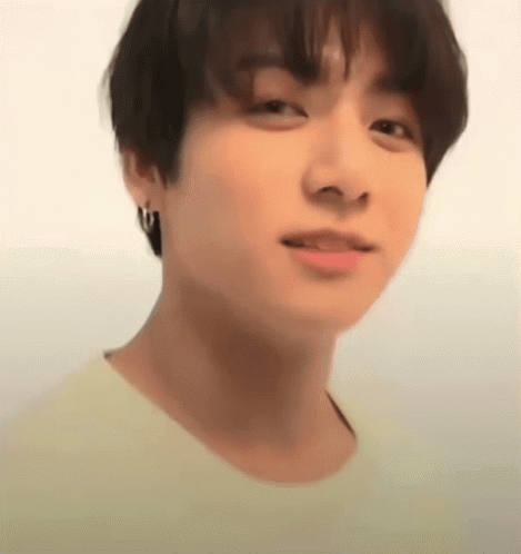 A softly blurred young man looks toward the camera.