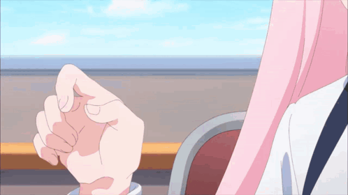 a person 's hand is being held by another person in a pink shirt