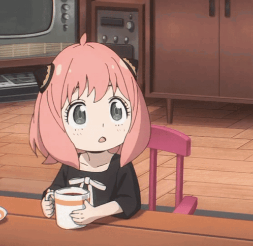Anya Forger holds a mug and looks wide-eyed in surprise.