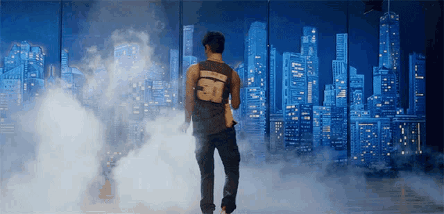 a man in a tank top with the number 50 on the back stands in front of a city skyline
