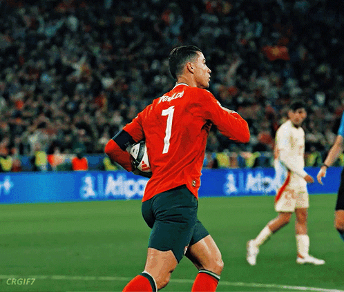 a soccer player wearing a red jersey with the number 1 on it