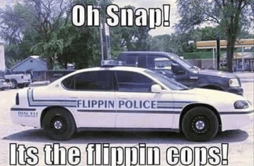 a white flippin police car is parked next to a black truck