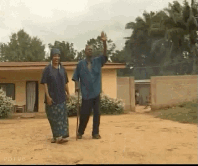 a man and a woman walking down a dirt road with pdiv6 written on the bottom right