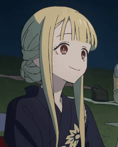 a girl with long blonde hair is wearing a black shirt with a flower on the sleeve