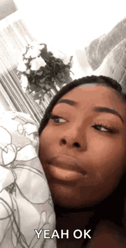 Woman gives a knowing sideways look with “YEAH OK.”