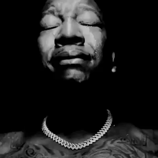 A man cries dramatically in black and white.
