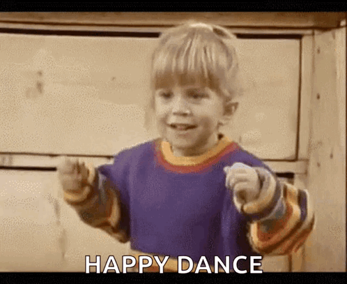 A young boy points and dances with “HAPPY DANCE.”