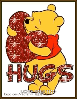 Winnie the Pooh hugs a glittery red heart above the word “HUGS.”