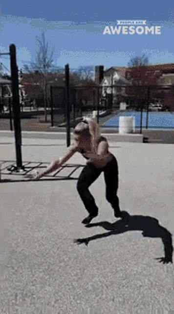 a woman is doing a trick on a skateboard in a park with awesome written on the bottom