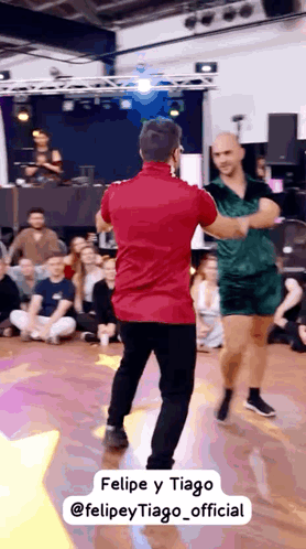 a man in a red shirt is dancing with another man in a green dress ..
