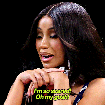 Cardi B recoils with clasped hands, captioned “I’m so scared! Oh my gosh!”