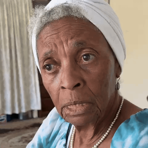 An older woman gives a sharp skeptical side-eye.