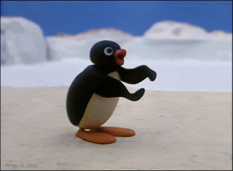 Pingu claps in the snow while holding a small red ball.