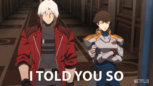 a man in a red jacket is standing next to another man with the words i told you so behind him