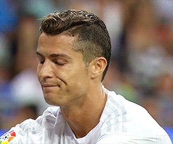 a close up of a soccer player wearing a white shirt with the word adidas on it