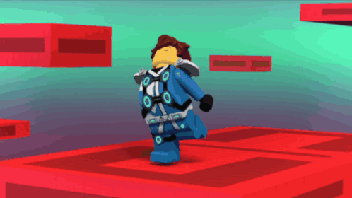 a lego character is standing on a red cube