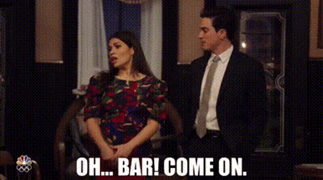 a man and woman are standing next to each other in a room .